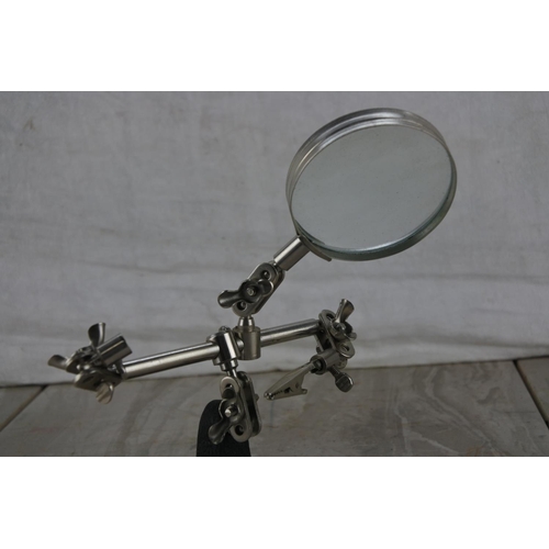 351 - A magnifying glass on mounted on a stand.