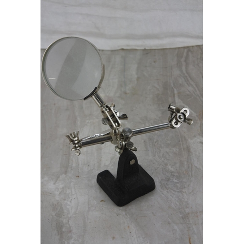 351 - A magnifying glass on mounted on a stand.