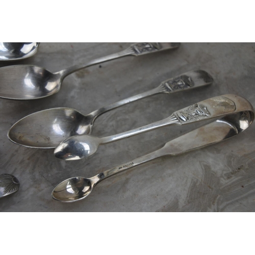 364 - A stunning set of 12 electroplated tea spoons and a pair of sugar nips with a decorative pattern.