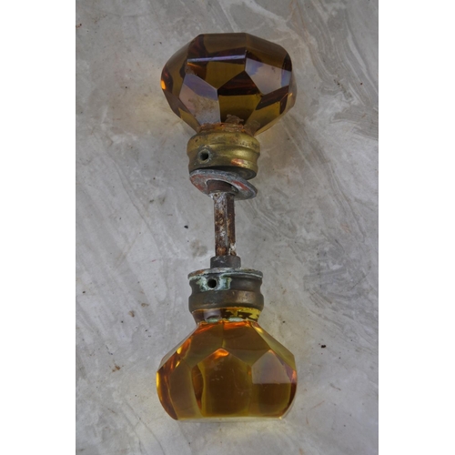 367 - An antique amber glass door handle.