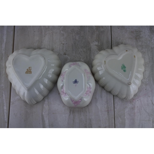 386 - Two Belleek pottery heart shaped dishes - green and brown stamp, and a Belleek pottery shell dish - ... 