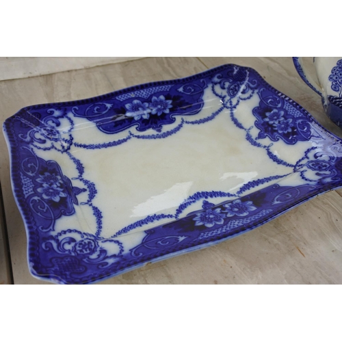 387 - A Willow patterned teapot, six side plates and a square floral pattern blue platter.