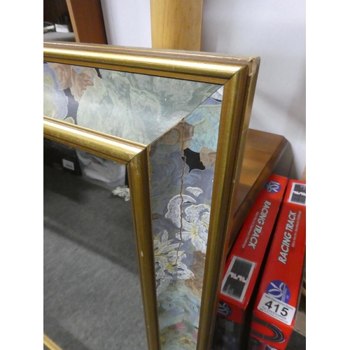 414 - A floral patterned framed mirror. Approx 64x84cm.