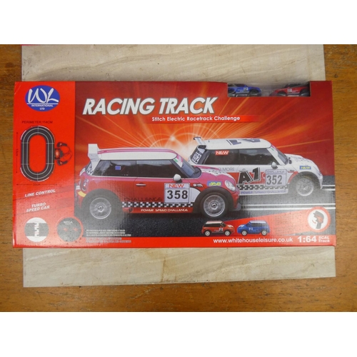 415 - Two boxed W L International Ltd racing track and cars.