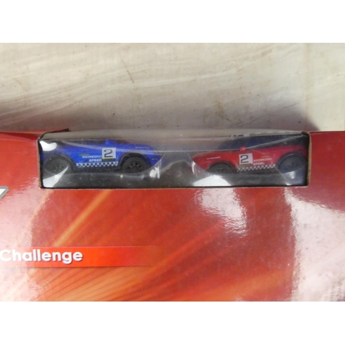 415 - Two boxed W L International Ltd racing track and cars.