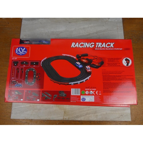 415 - Two boxed W L International Ltd racing track and cars.