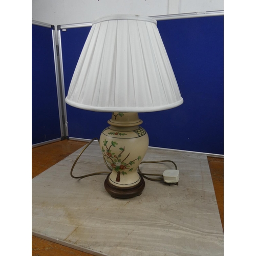 453 - A stunning floral patterned ceramic based table lamp and shade. Approx 48cm.