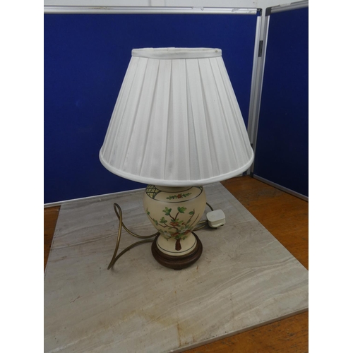 453 - A stunning floral patterned ceramic based table lamp and shade. Approx 48cm.