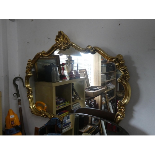 486 - A stunning gilt framed mirror with scroll detail. Approx 120x88cm.