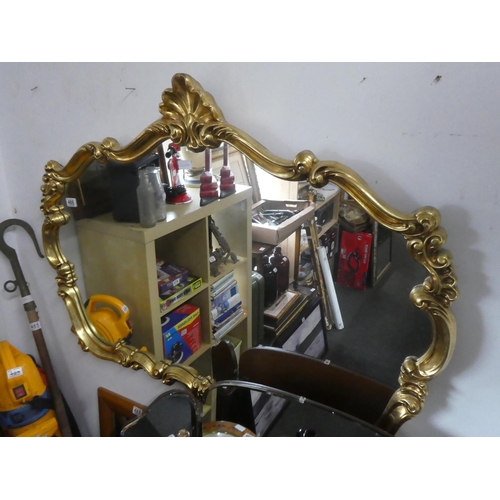 486 - A stunning gilt framed mirror with scroll detail. Approx 120x88cm.