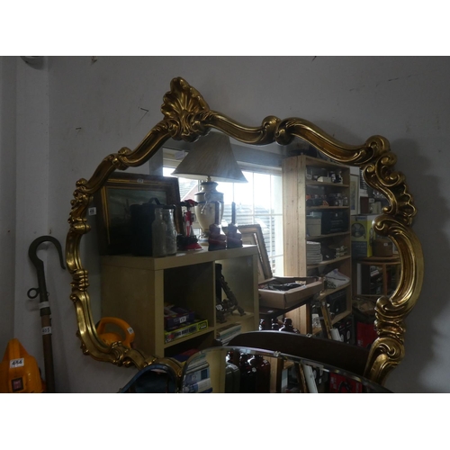 486 - A stunning gilt framed mirror with scroll detail. Approx 120x88cm.