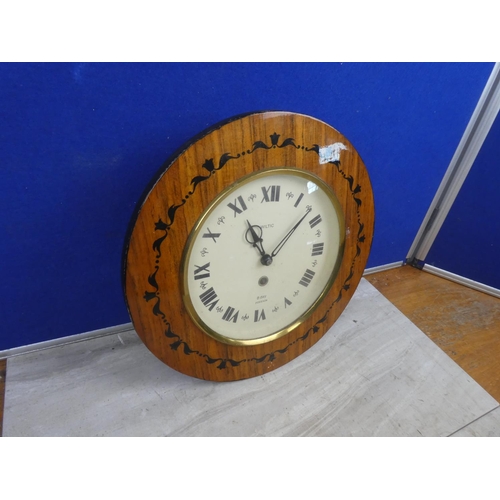 489 - A Wiltic 8 day wall clock with decorative frame.