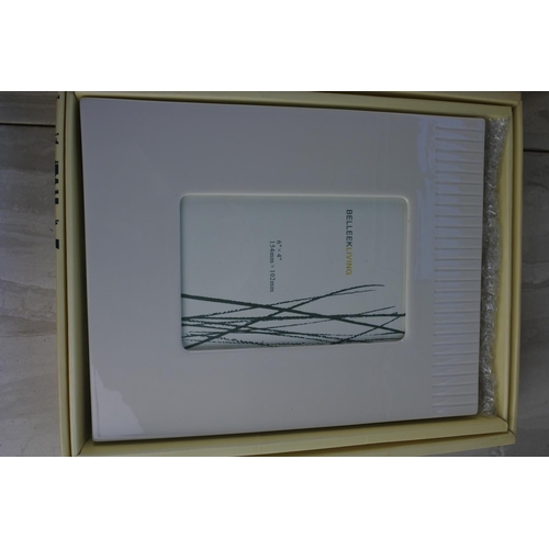 544 - Two boxed Belleek Living photograph frames.