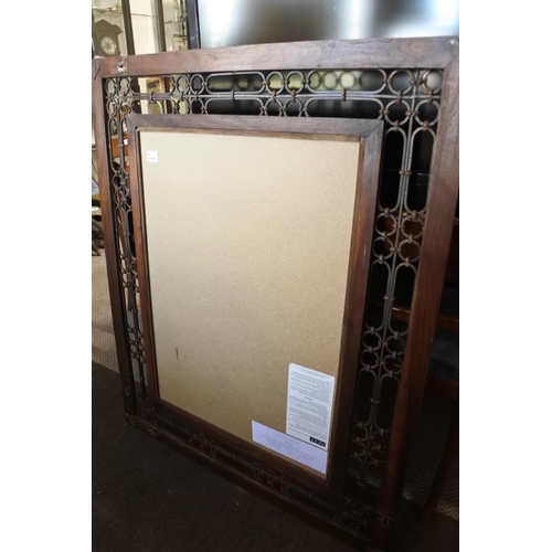 549 - A large wooden and wrought iron framed wall mirror. Approx 90x110cm.