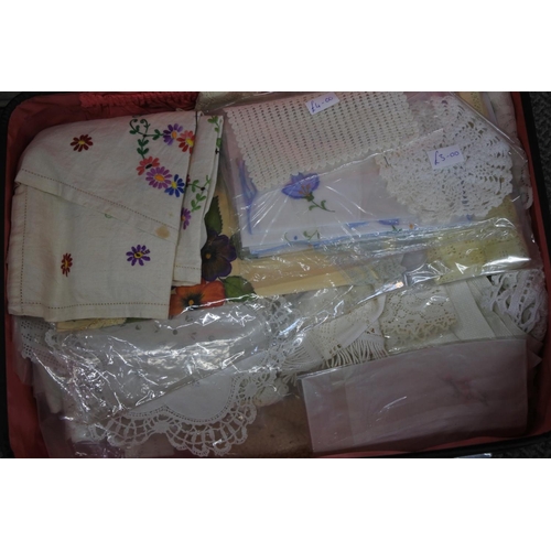 584 - A vintage Crown suitcase and a lot of various linen.