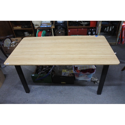 585 - An Ikea dining room table on a metal base.