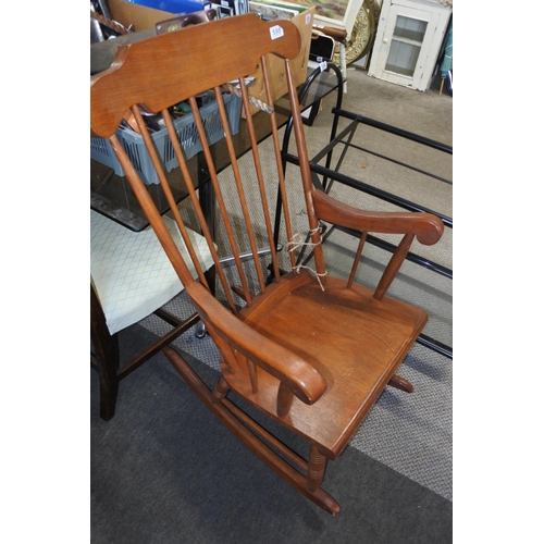 598 - A wooden high backed rocking chair.