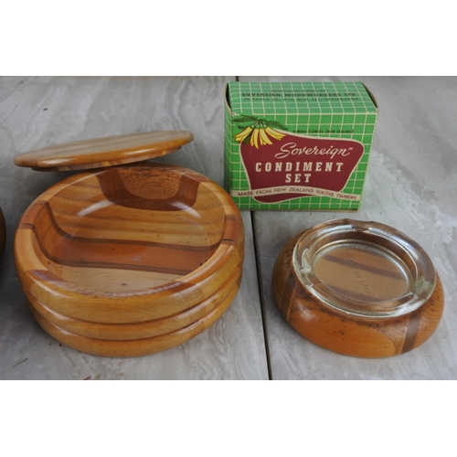 733 - A vintage New Zealand wooden lidded dish, another, an ashtray and a boxed condiment set.