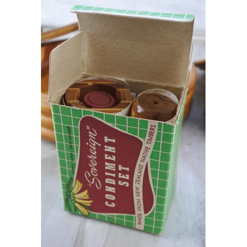 733 - A vintage New Zealand wooden lidded dish, another, an ashtray and a boxed condiment set.