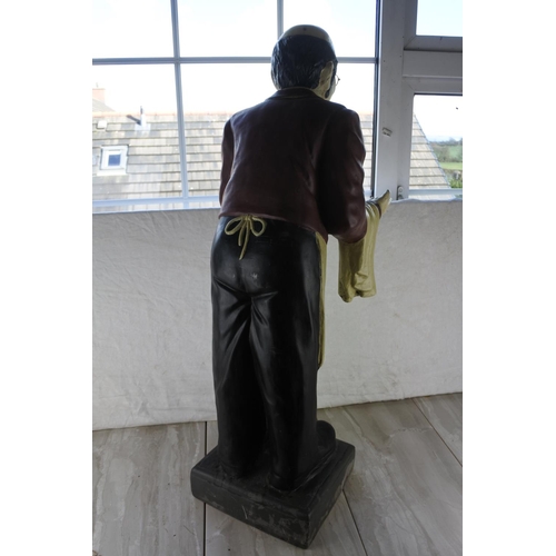 741 - A large statue of an old man waiter.  Approx 95cm.