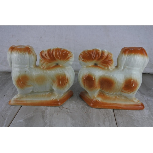 750 - A pair of antique Staffordshire mantle dogs.  Approx 20cm.