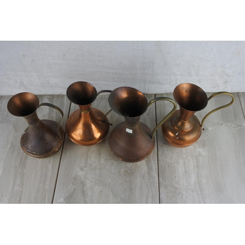 783 - Four vintage copper jugs.