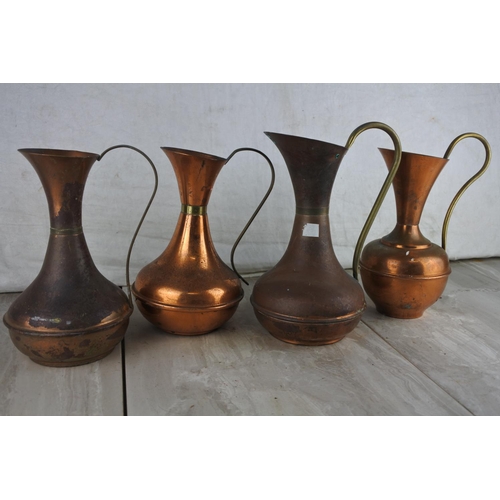 783 - Four vintage copper jugs.