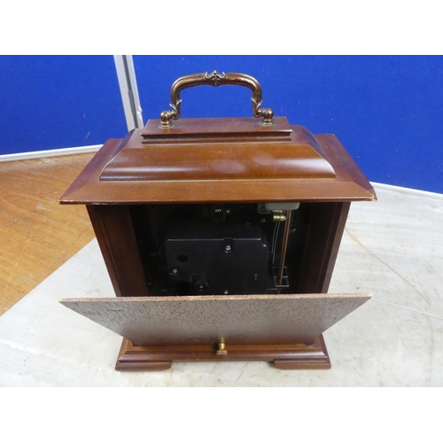 805 - A wooden cased Rhythm mantle clock.