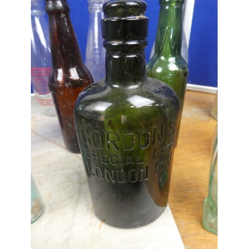 820 - A collection of vintage glass bottles to include Killyman Dairies, Gordon's Gin, Bovril Limited, P M... 