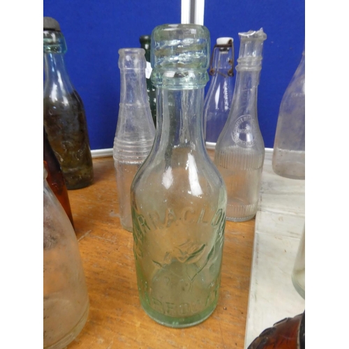 820 - A collection of vintage glass bottles to include Killyman Dairies, Gordon's Gin, Bovril Limited, P M... 