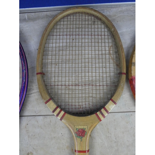 827 - A vintage Improved badminton racket, a vintage Waratah tennis racket and two others.