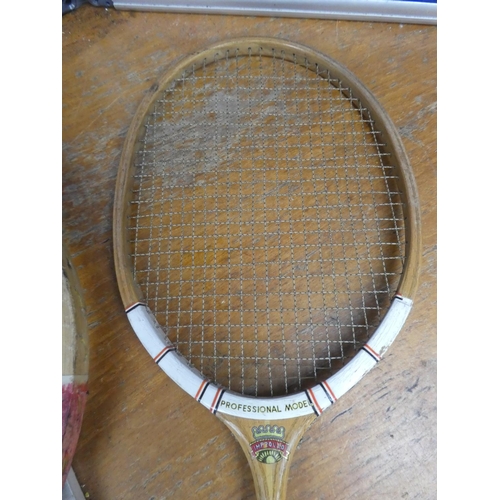 827 - A vintage Improved badminton racket, a vintage Waratah tennis racket and two others.