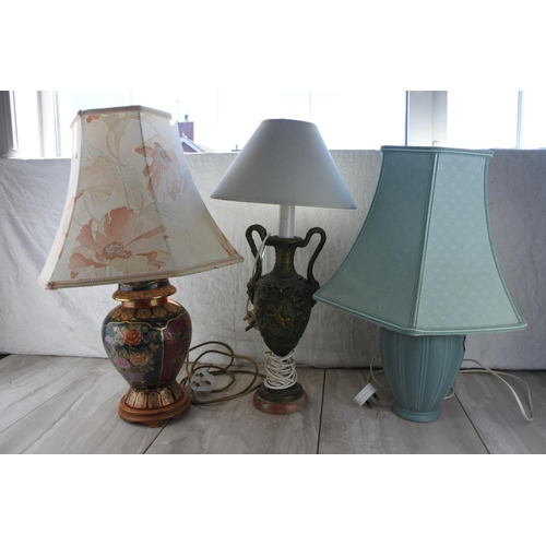 852 - An antique style metal based table lamp and shade with ornate detail.  Approx 60cm.