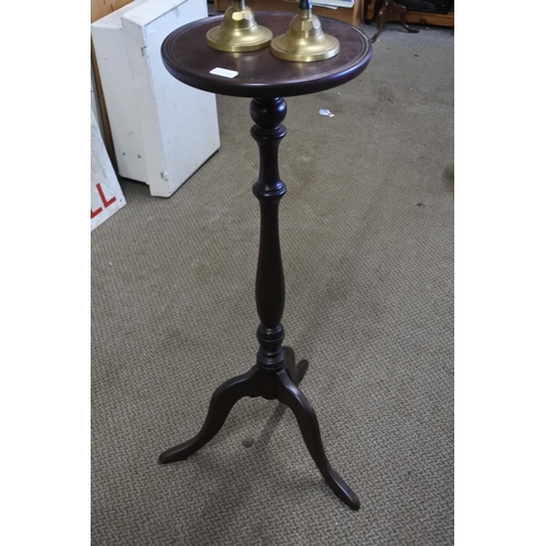 858 - A Logan's mahogany plantstand and a pair of brass and painted candlesticks.  Approx 88cm.