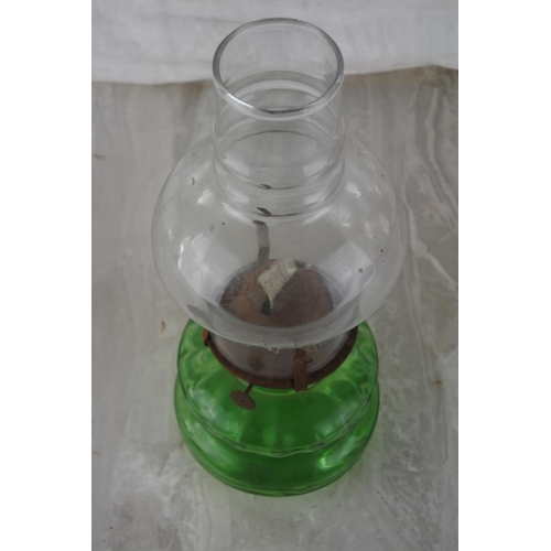 861 - A vintage green glass oil lamp.  Approx 30cm.