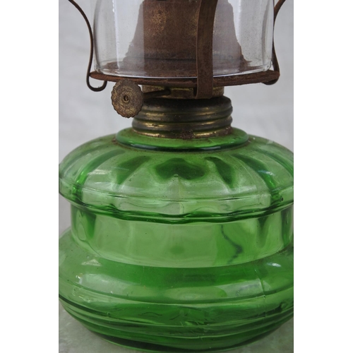 861 - A vintage green glass oil lamp.  Approx 30cm.