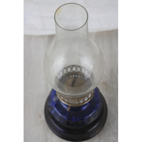 862 - A vintage blue glass oil lamp.  Approx 30cm.