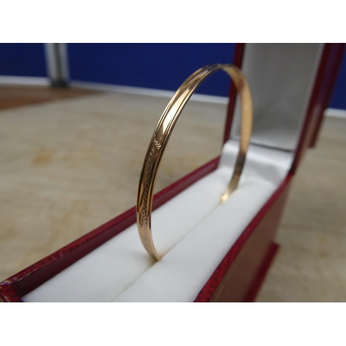 903 - A child's rolled gold bangle.