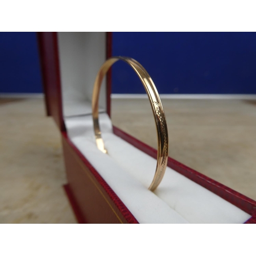 903 - A child's rolled gold bangle.