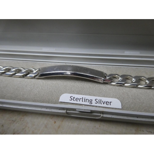 904 - A sterling silver identity bracelet.