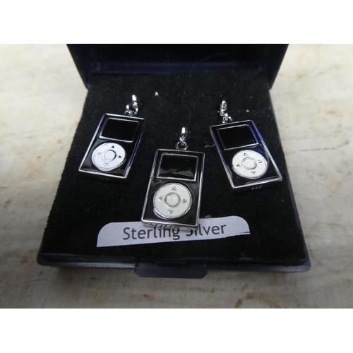 906 - Three sterling silver iPod charms.