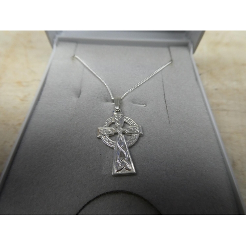 909 - A sterling silver chain and cross pendant.