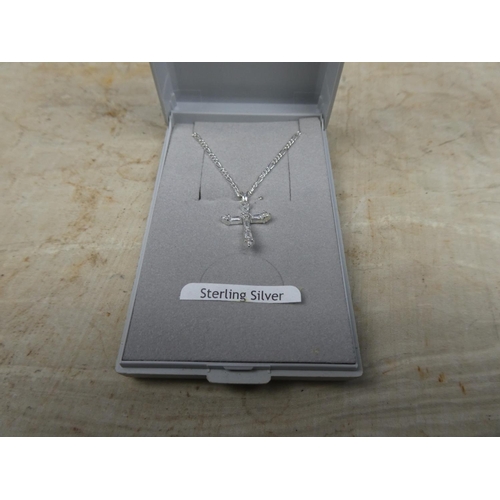 910 - A sterling silver chain and cubic zirconia cross pendant.