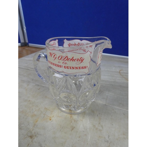 935 - A vintage W G O'Doherty Wine and Spirits Merchant glass jug (a/f).