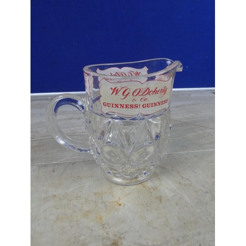 935 - A vintage W G O'Doherty Wine and Spirits Merchant glass jug (a/f).