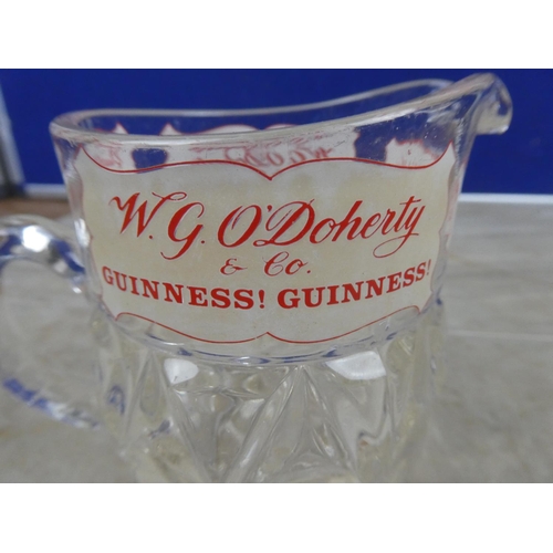 935 - A vintage W G O'Doherty Wine and Spirits Merchant glass jug (a/f).