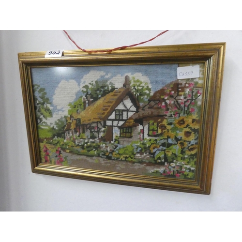 953 - A framed tapestry of a cottage scene.  Approx 42x29cm.