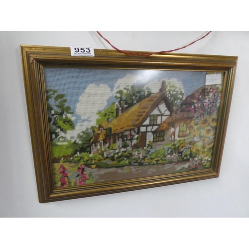 953 - A framed tapestry of a cottage scene.  Approx 42x29cm.