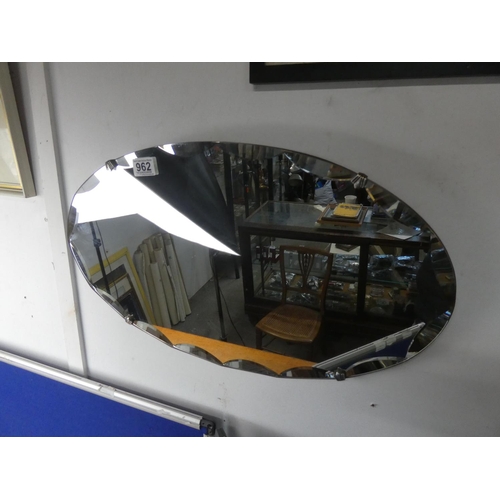 962 - An unframed vintage mirror with bevelled detail.  Approx 60x35cm.