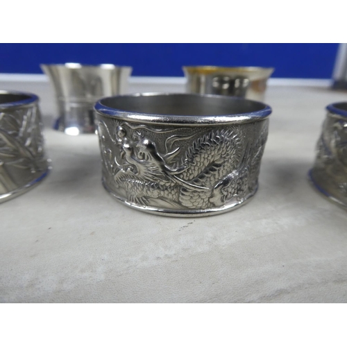 968 - Four silver plated pattern napkin rings and three others.